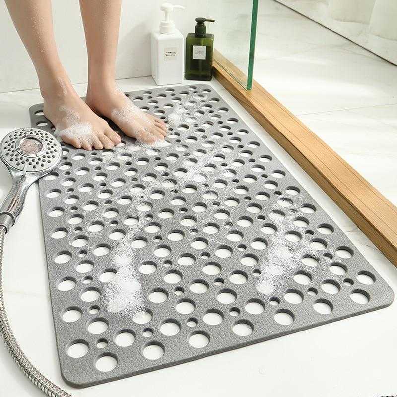 Un tapis de douche antidérapant devant une baignoire